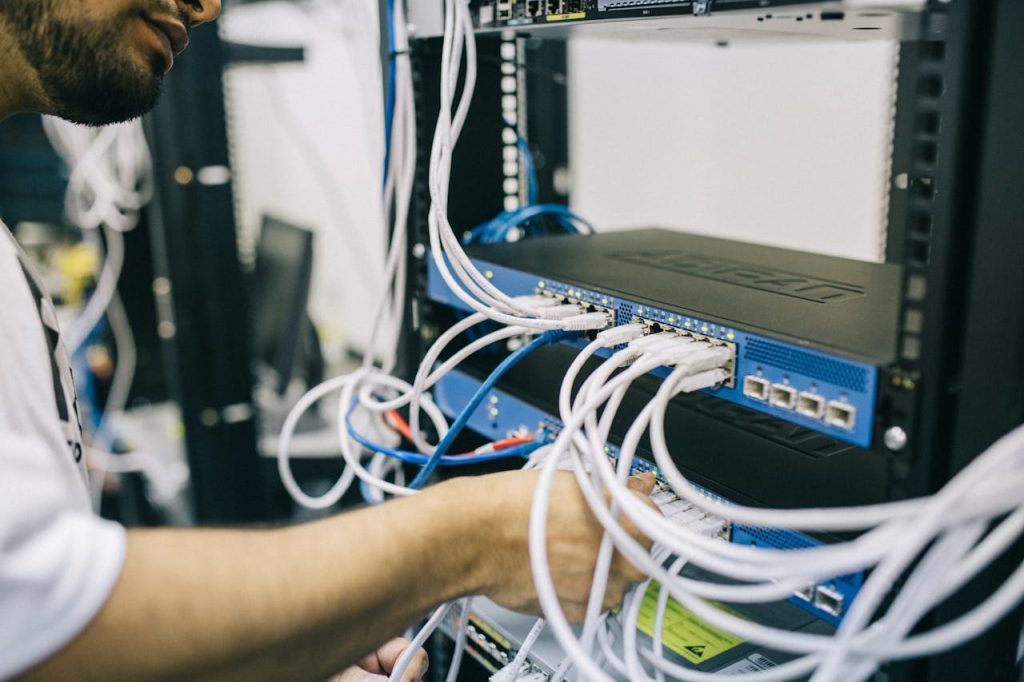 pexels-photo-442150 Electronics Engineer Fixing Cables on Server